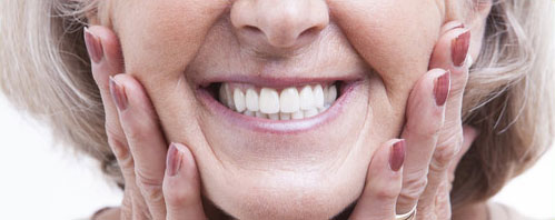 A woman with white teeth smiling for the camera.